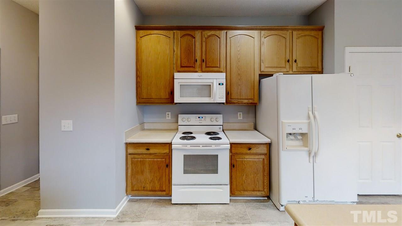 4348 Cardinal Grove Boulevard Raleigh, NC 27616 - Photo 15 of 30 a kitchen with a stove and a cabinet