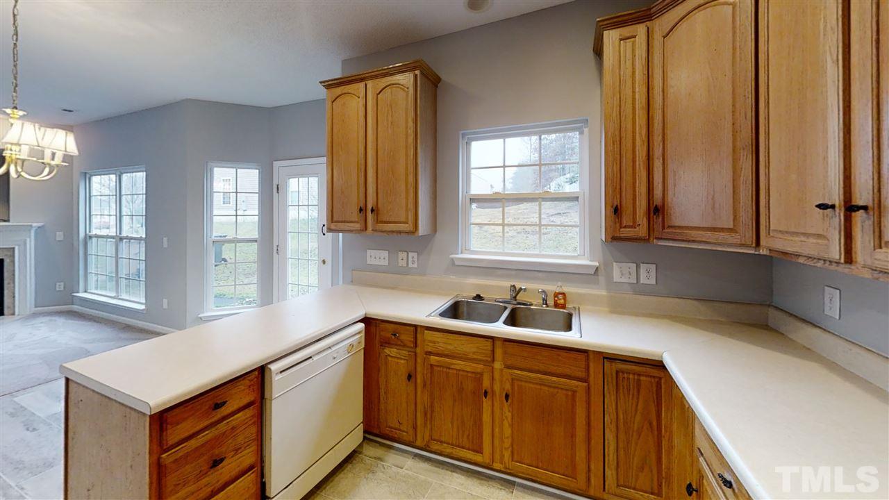 4348 Cardinal Grove Boulevard Raleigh, NC 27616 - Photo 16 of 30 a kitchen with stainless steel appliances a sink window and cabinets