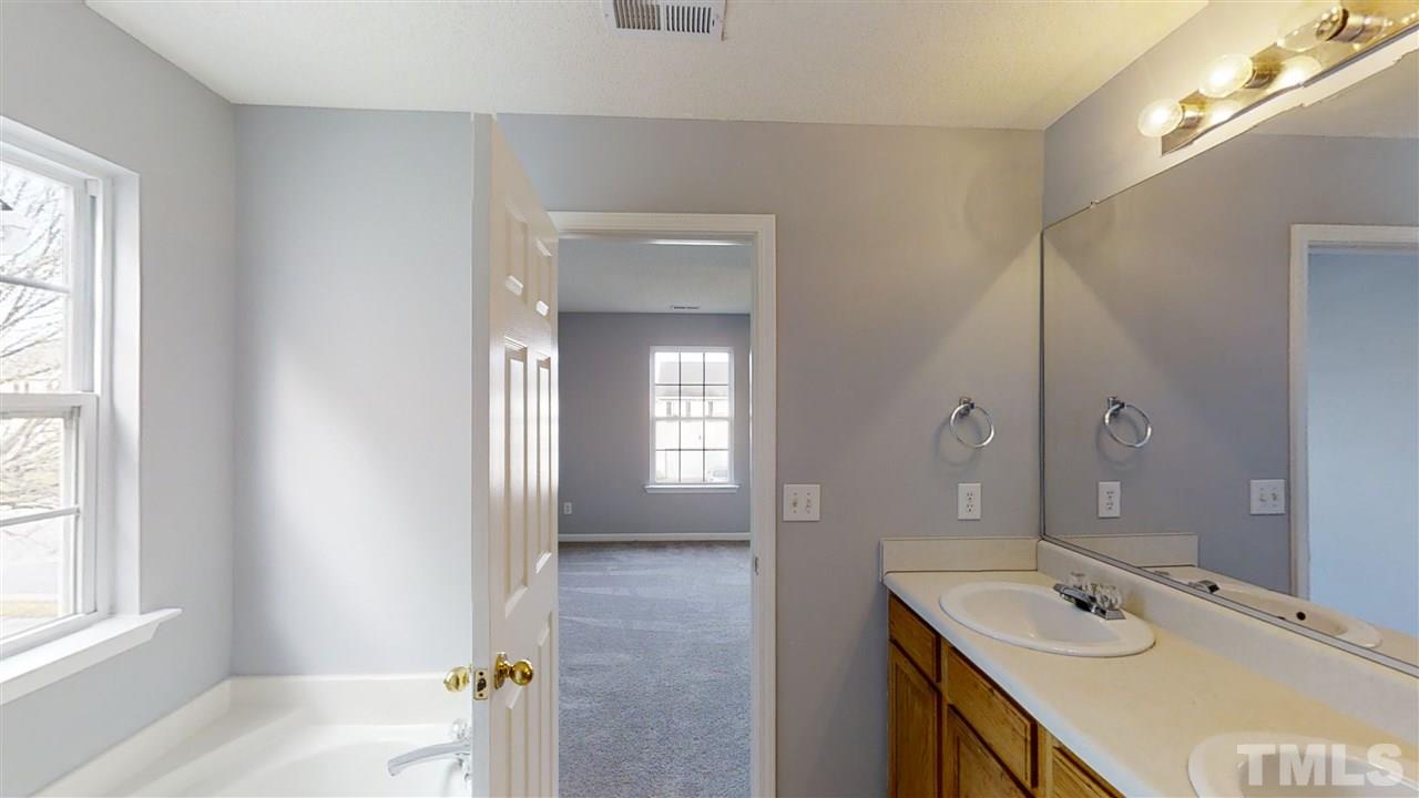4348 Cardinal Grove Boulevard Raleigh, NC 27616 - Photo 18 of 30 a bathroom with a sink and a mirror