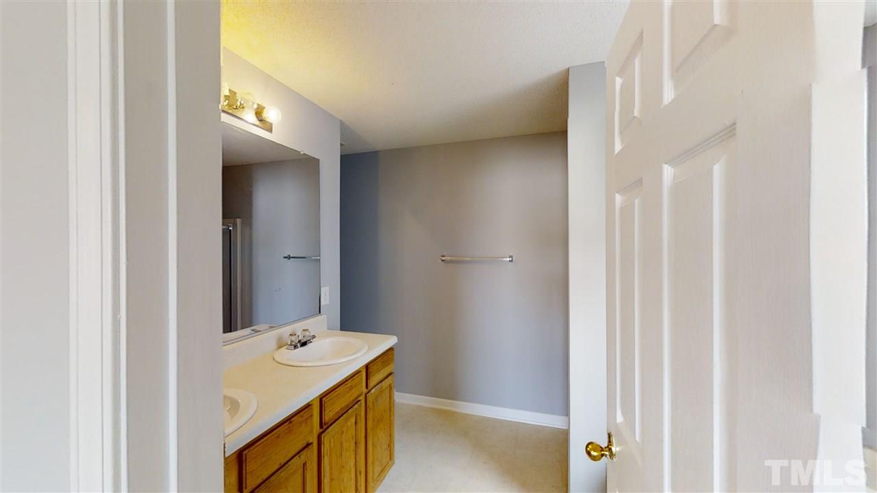 4348 Cardinal Grove Boulevard Raleigh, NC 27616 - Photo 19 of 30 a bathroom with a sink and mirror