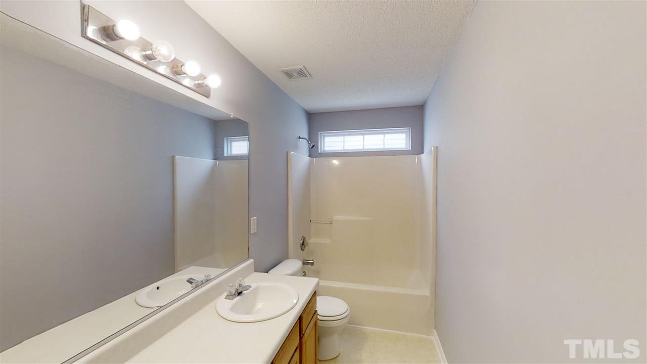 4348 Cardinal Grove Boulevard Raleigh, NC 27616 - Photo 21 of 30 a bathroom with a sink a toilet and shower