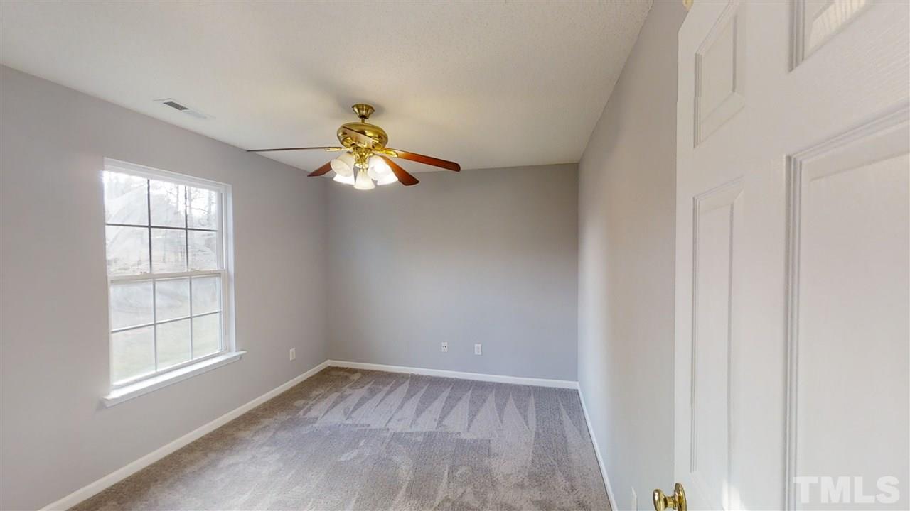 4348 Cardinal Grove Boulevard Raleigh, NC 27616 - Photo 24 of 30 an empty room with windows and chandelier fan