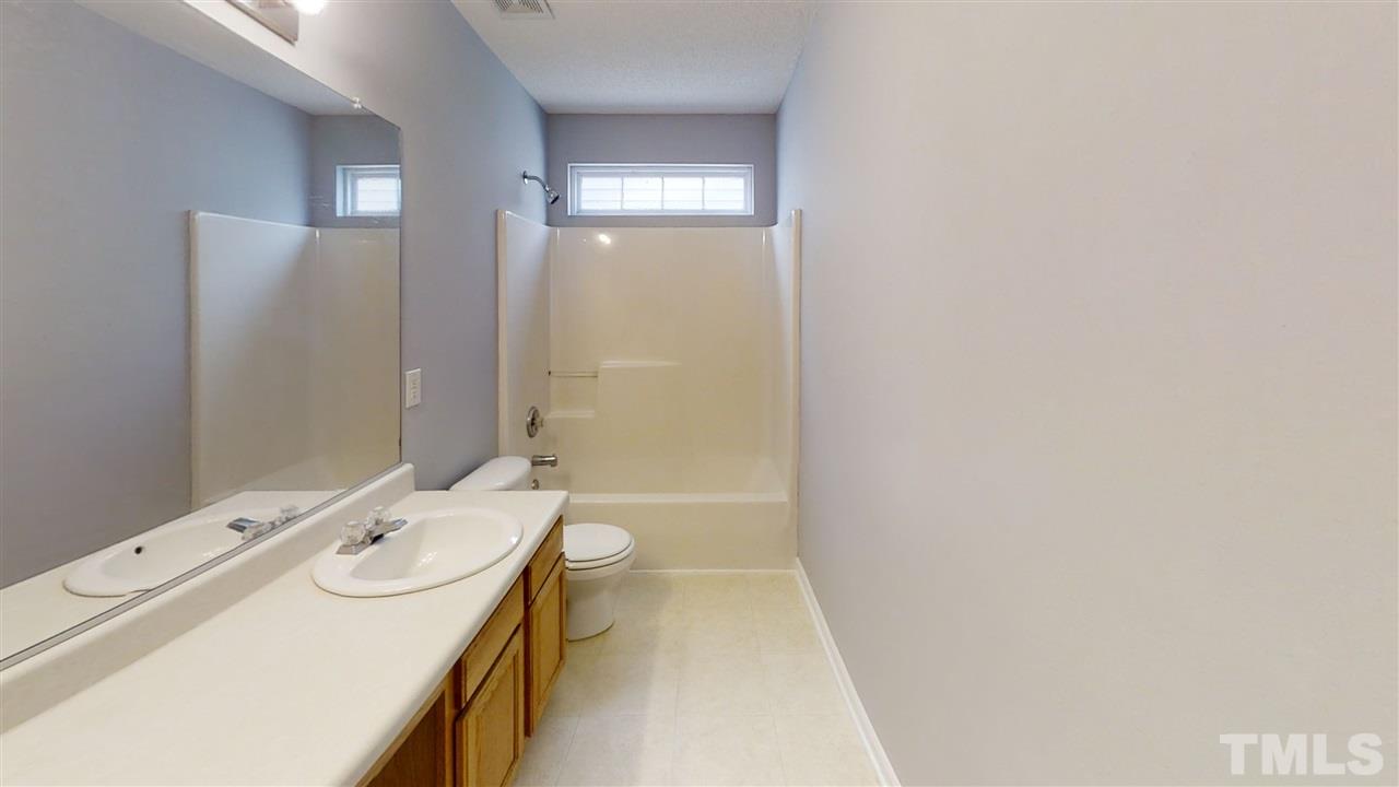 4348 Cardinal Grove Boulevard Raleigh, NC 27616 - Photo 25 of 30 a bathroom with a sink a toilet and shower