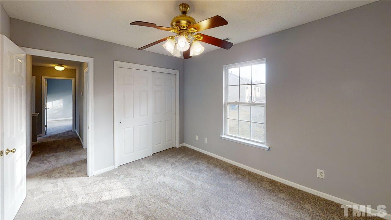 4348 Cardinal Grove Boulevard Raleigh, NC 27616 - Photo 28 of 30 an empty room with windows and fan