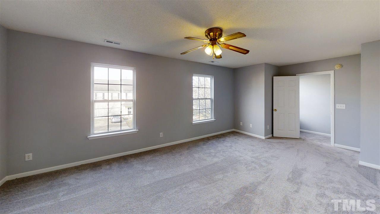 4348 Cardinal Grove Boulevard Raleigh, NC 27616 - Photo 29 of 30 an empty room with windows and chandelier fan