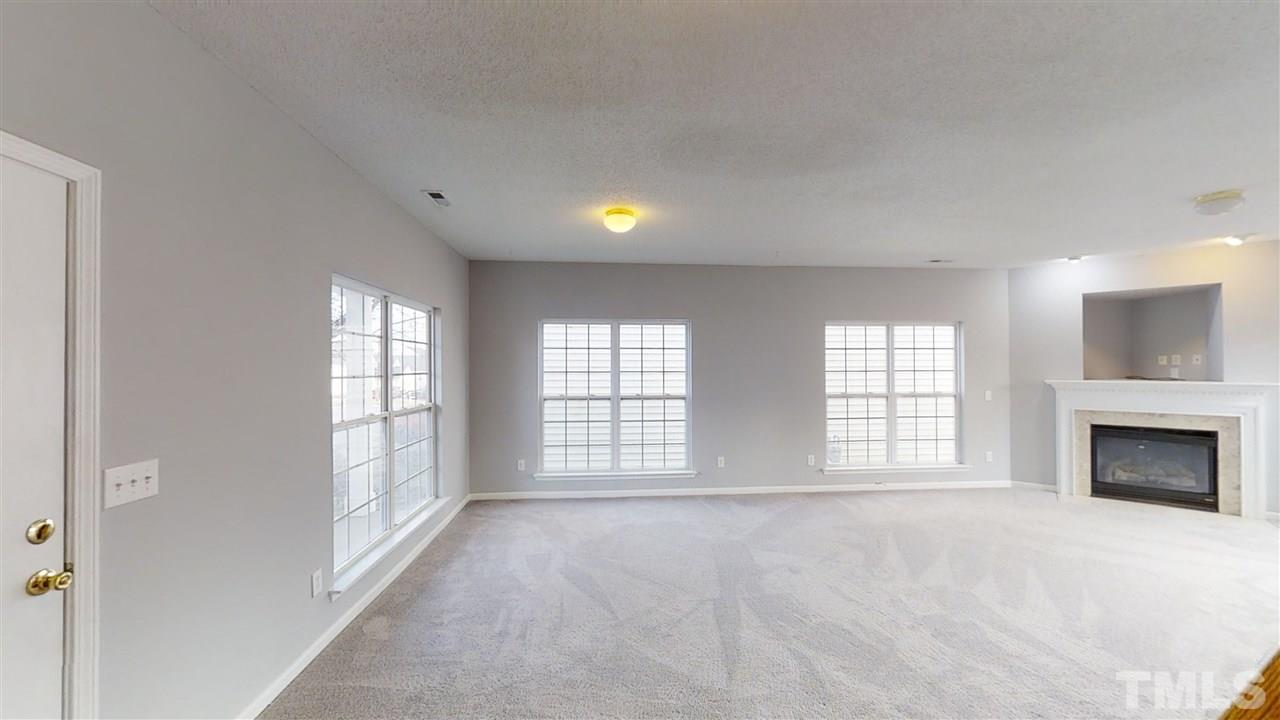 4348 Cardinal Grove Boulevard Raleigh, NC 27616 - Photo 4 of 30 a view of an empty room with a window and fireplace