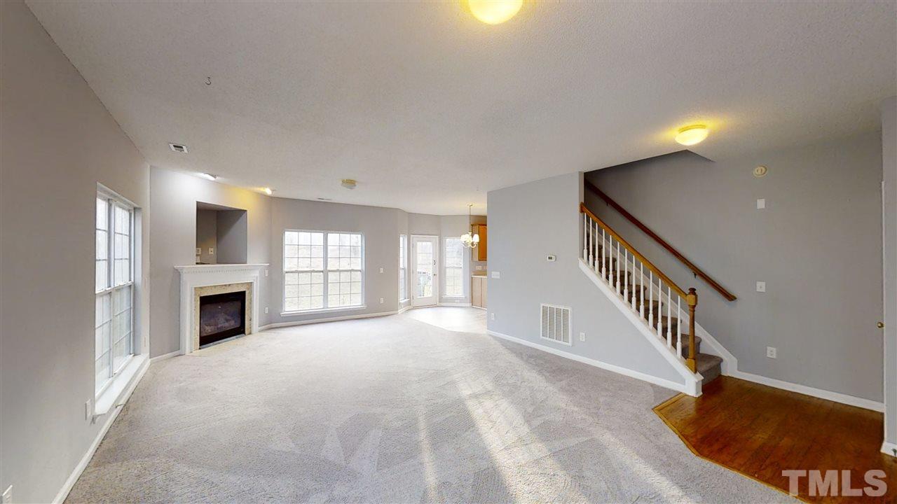 4348 Cardinal Grove Boulevard Raleigh, NC 27616 - Photo 5 of 30 a view of a livingroom with a fireplace window and stairs