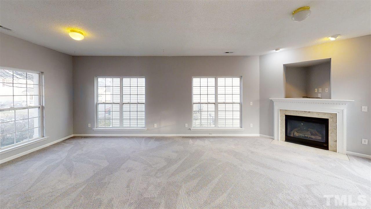 4348 Cardinal Grove Boulevard Raleigh, NC 27616 - Photo 9 of 30 a view of an empty room with a window and fireplace