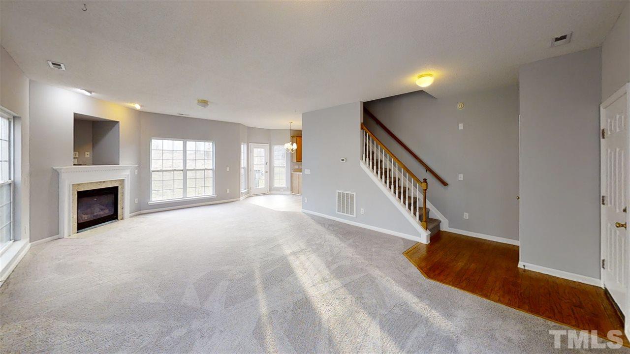 4348 Cardinal Grove Boulevard Raleigh, NC 27616 - Photo 10 of 30 a view of an empty room with wooden floor and a window