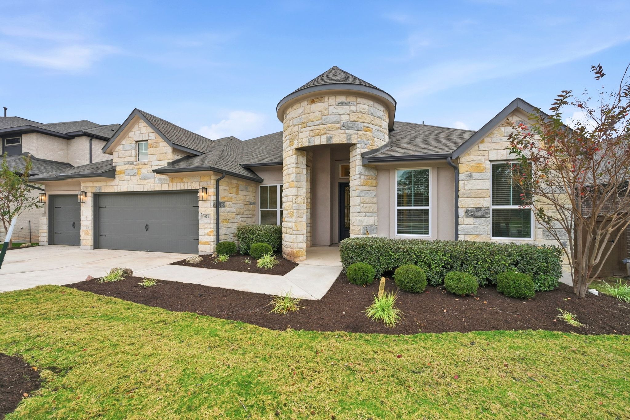 a front view of a house with a yard and garage