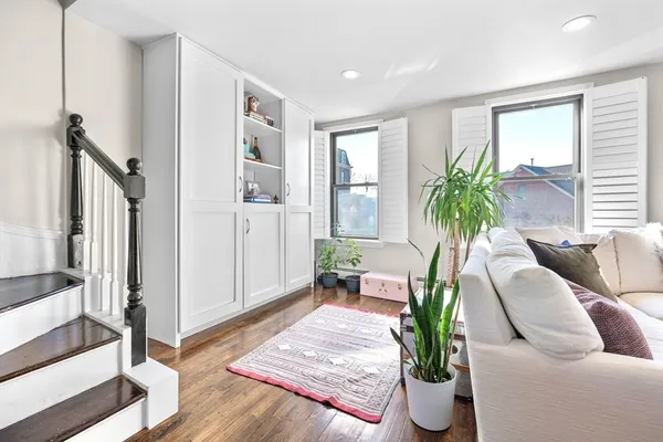 a living room with furniture and a potted plant