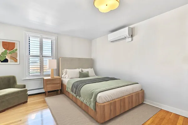 a bedroom with a bed couch and window