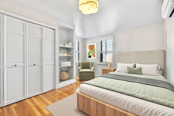 a bedroom with a bed and a chandelier