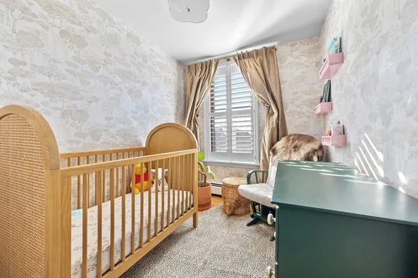 a bedroom with furniture and a window