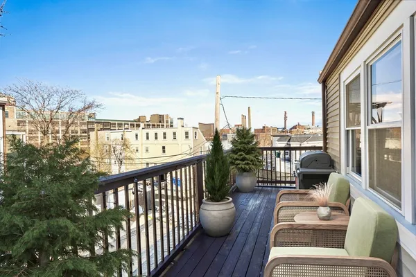 a view of a balcony with wooden floor