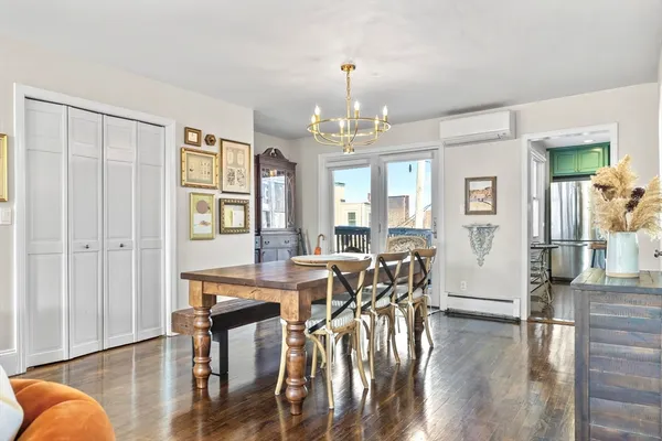 a view of a dining room with furniture window and wooden floor