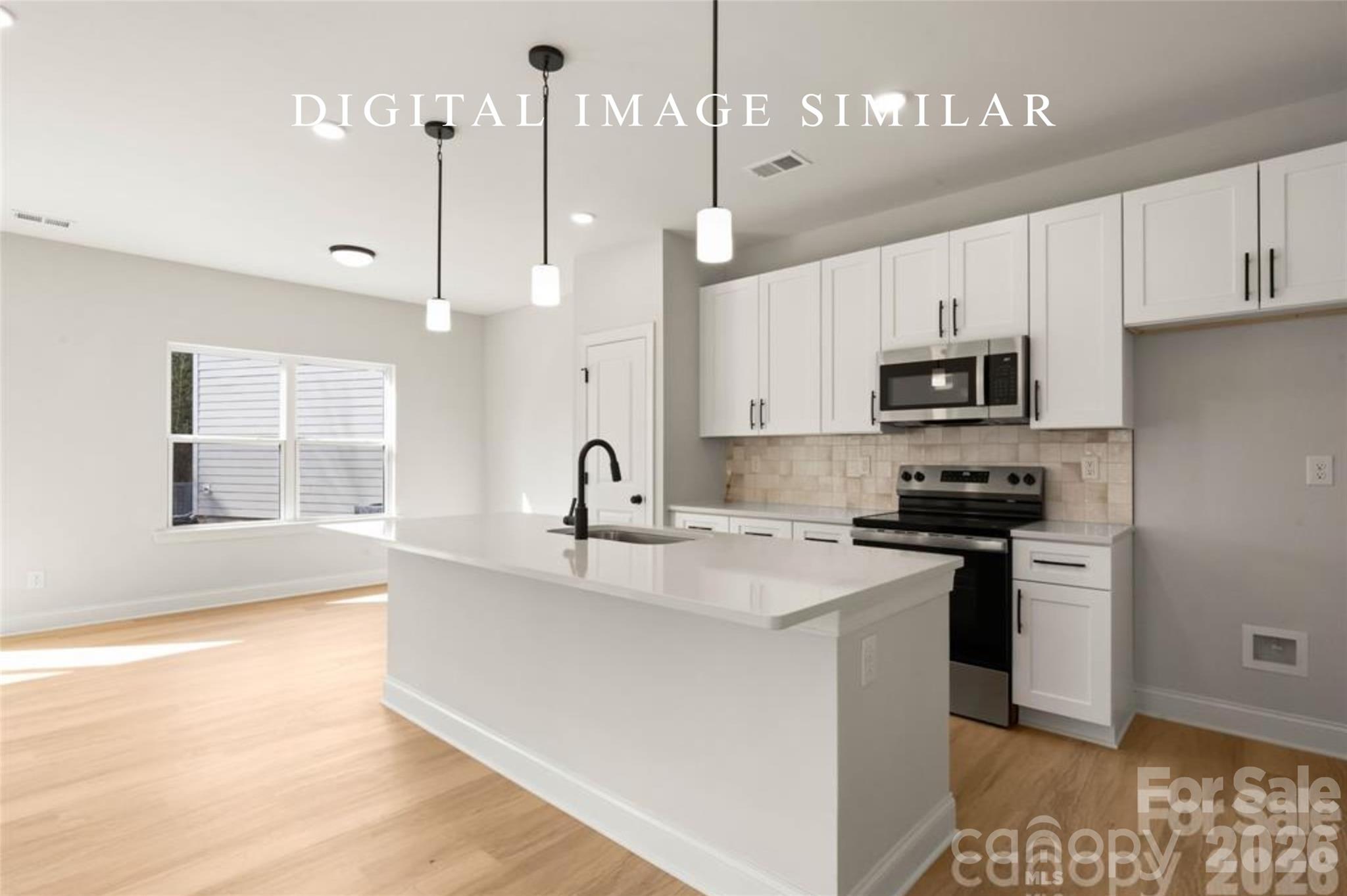 2928 Mulberry Church Road Charlotte, NC 28208 - Photo 7 of 43 a kitchen with stainless steel appliances granite countertop a sink a stove a refrigerator and white cabinets with wooden floor