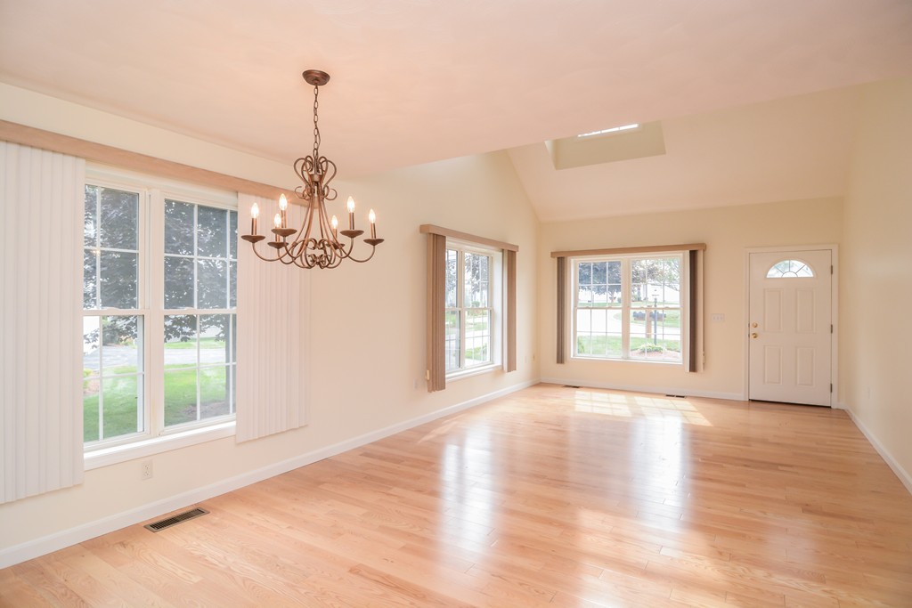 35 Hadleigh Road, Unit 35 Windham, NH 03087 - Photo 12 of 39 a view of an empty room with wooden floor and a window