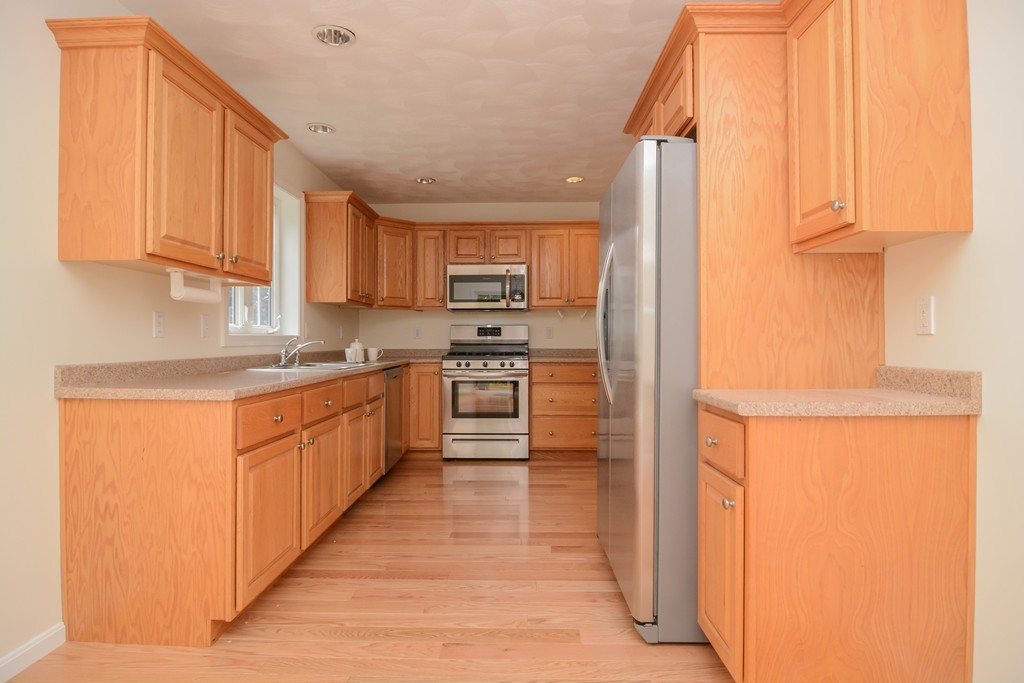 35 Hadleigh Road, Unit 35 Windham, NH 03087 - Photo 17 of 39 a large kitchen with stainless steel appliances granite countertop a refrigerator and a sink