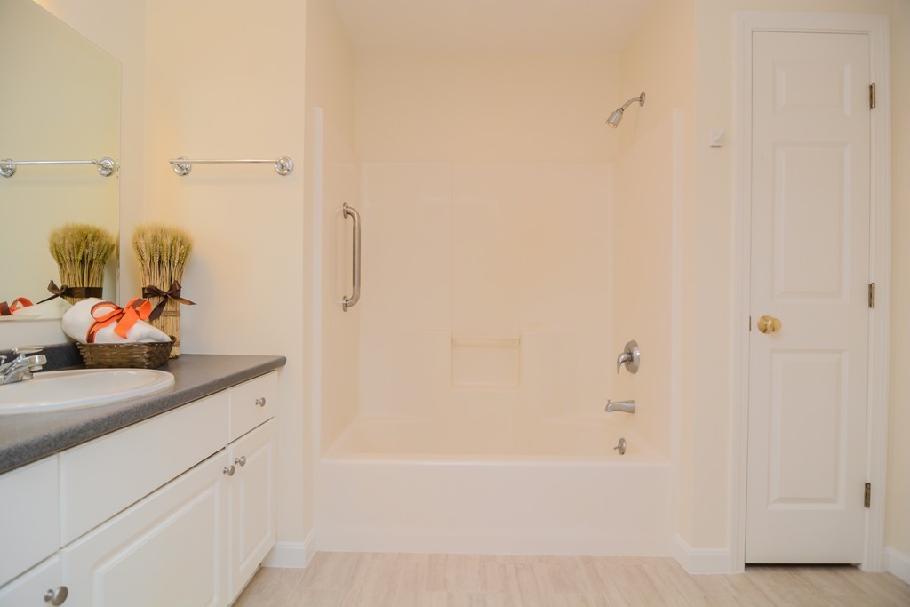 35 Hadleigh Road, Unit 35 Windham, NH 03087 - Photo 22 of 39 a bathroom with a granite countertop sink and a mirror