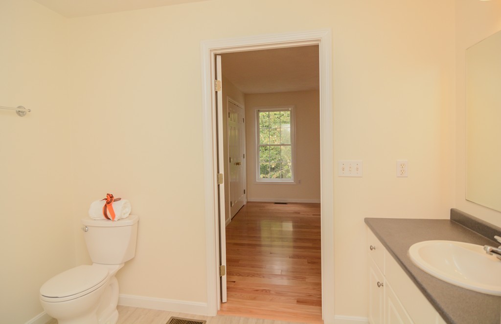 35 Hadleigh Road, Unit 35 Windham, NH 03087 - Photo 23 of 39 a bathroom with a granite countertop sink and a toilet