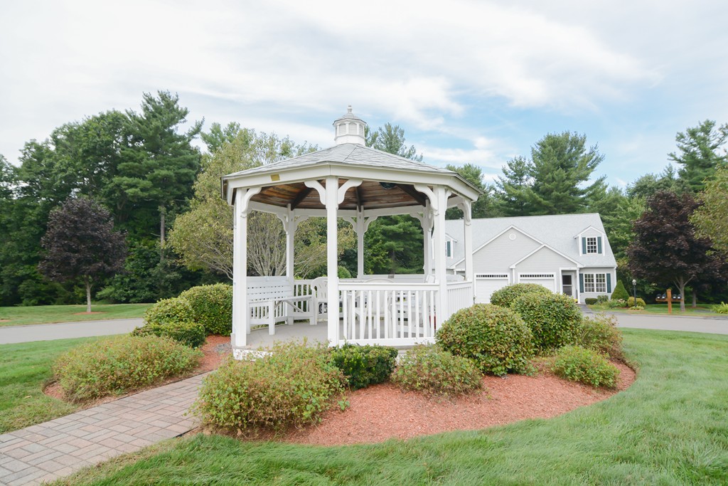 35 Hadleigh Road, Unit 35 Windham, NH 03087 - Photo 9 of 39 a view of house in front of a big yard with potted plants