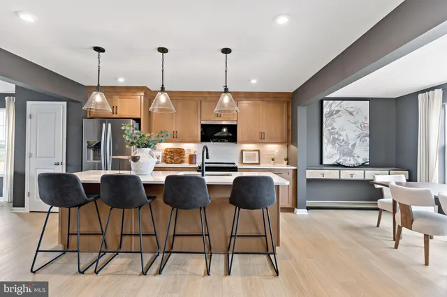 a kitchen with granite countertop a counter space dining table and chairs