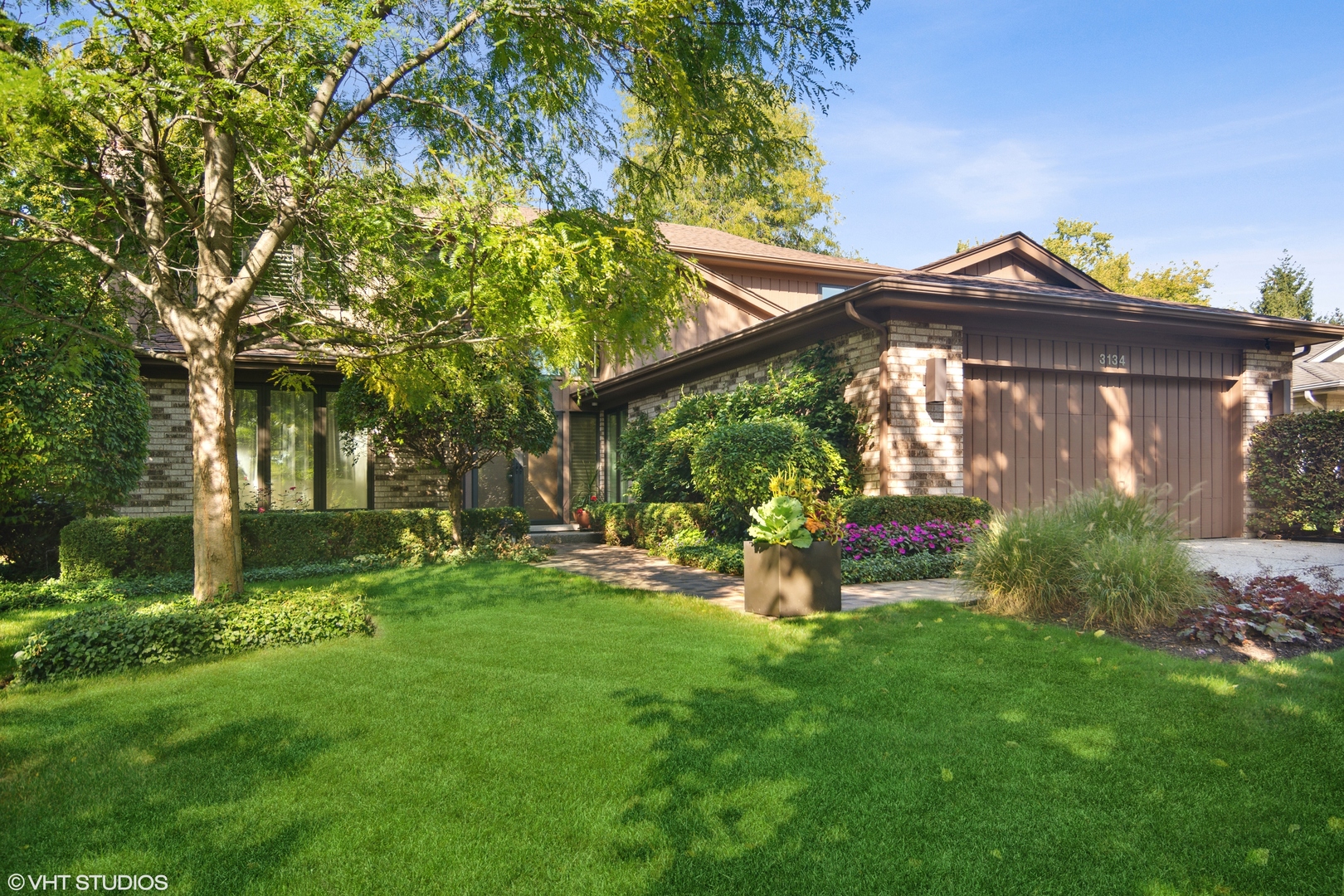 a view of a house with a yard and a garden
