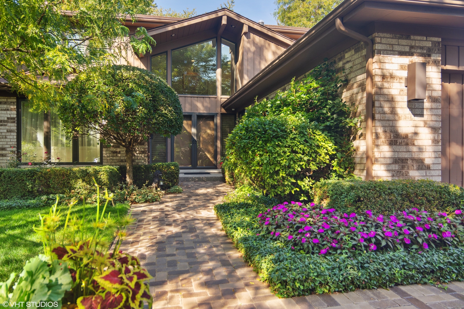 3134 Temple Lane Wilmette, IL 60091 - Photo 2 of 32 a view of a house with a big yard and flower plants