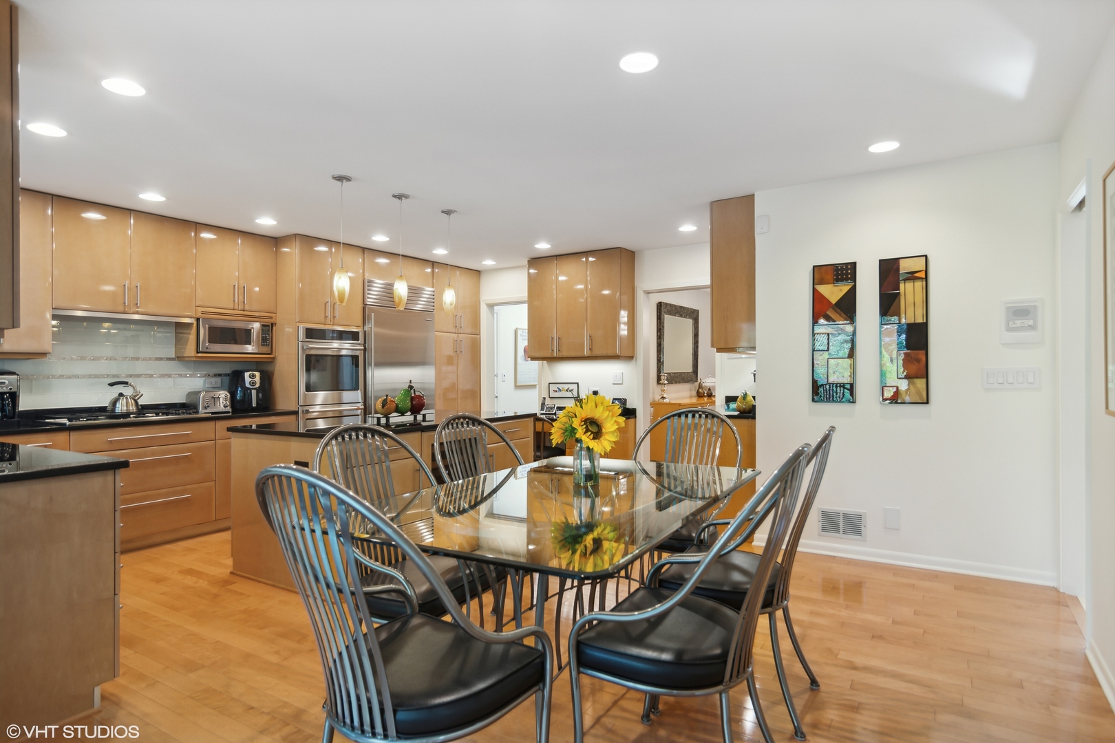 3134 Temple Lane Wilmette, IL 60091 - Photo 9 of 32 a dining room with stainless steel appliances kitchen island granite countertop a dining table chairs and kitchen view