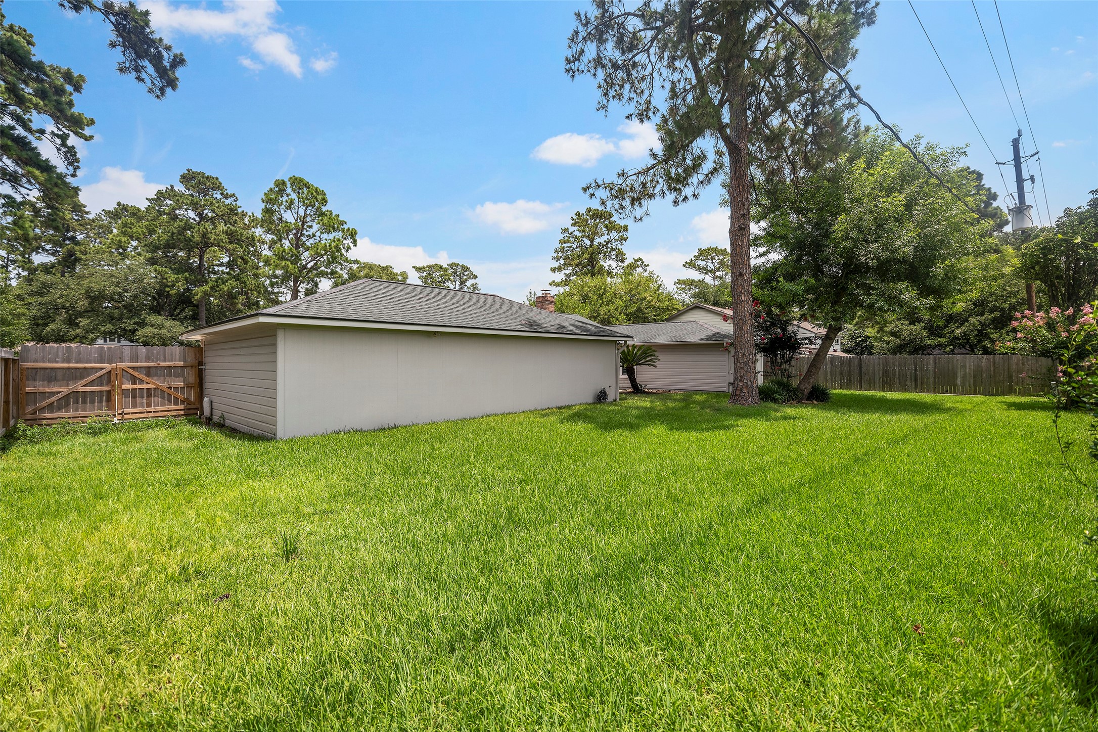 6507 Allentown Drive Spring, TX 77389 - Photo 24 of 30 Backyard view with double gates for drive-through access and additional storage.