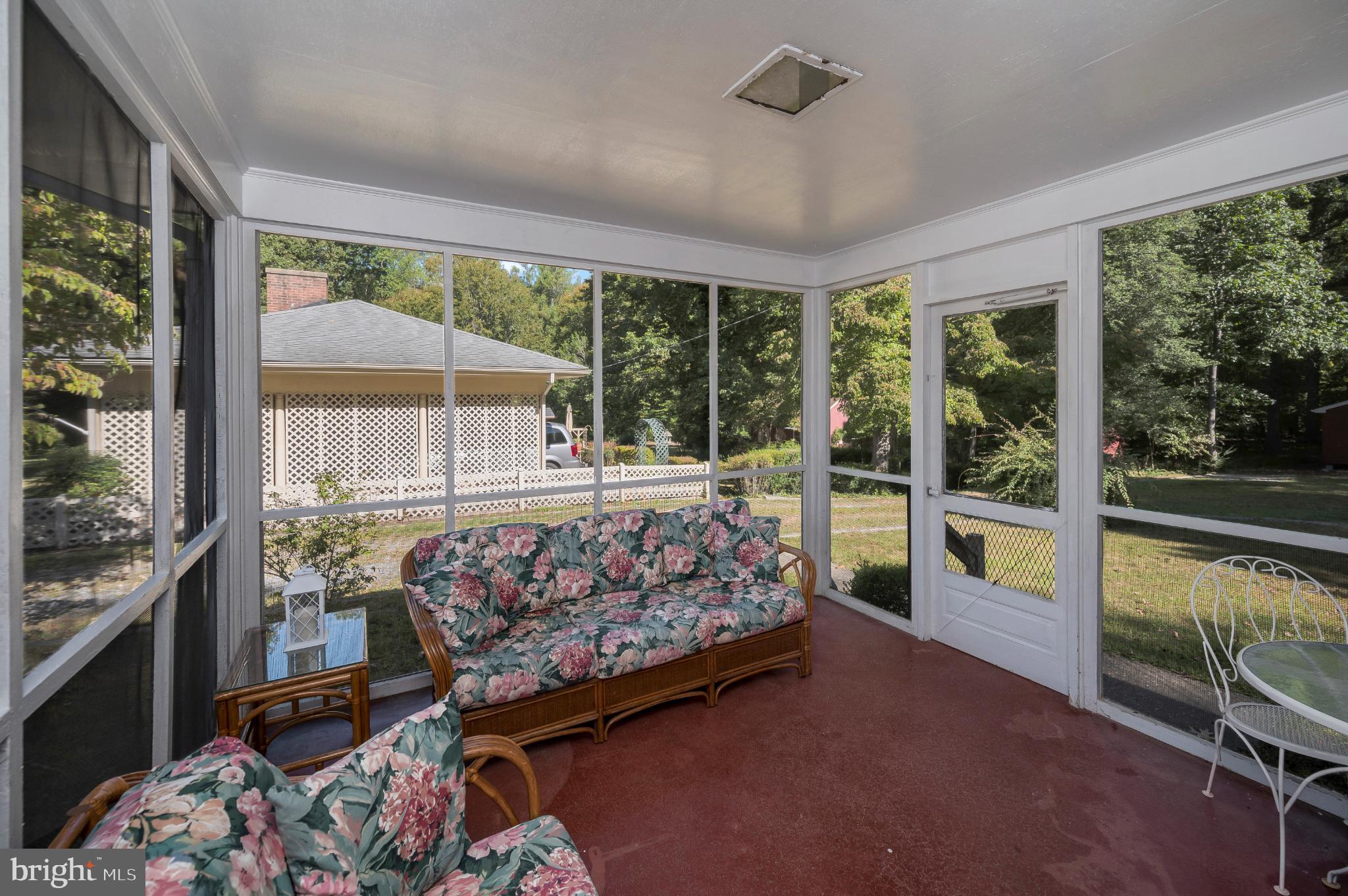 8625 Brock Road Spotsylvania, VA 22553 - Photo 25 of 47 Serene sunroom with lush garden views.