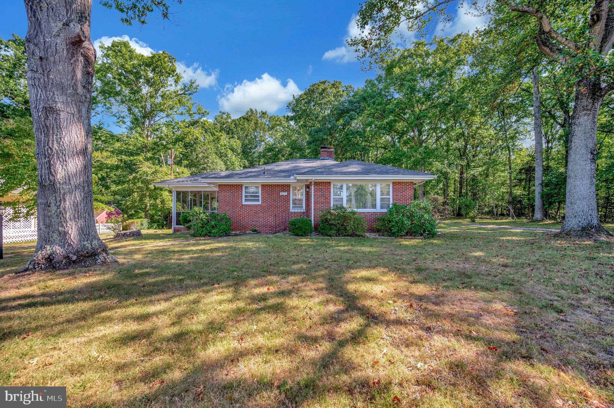 8625 Brock Road Spotsylvania, VA 22553 - Photo 40 of 47 Charming brick home nestled in lush greenery.