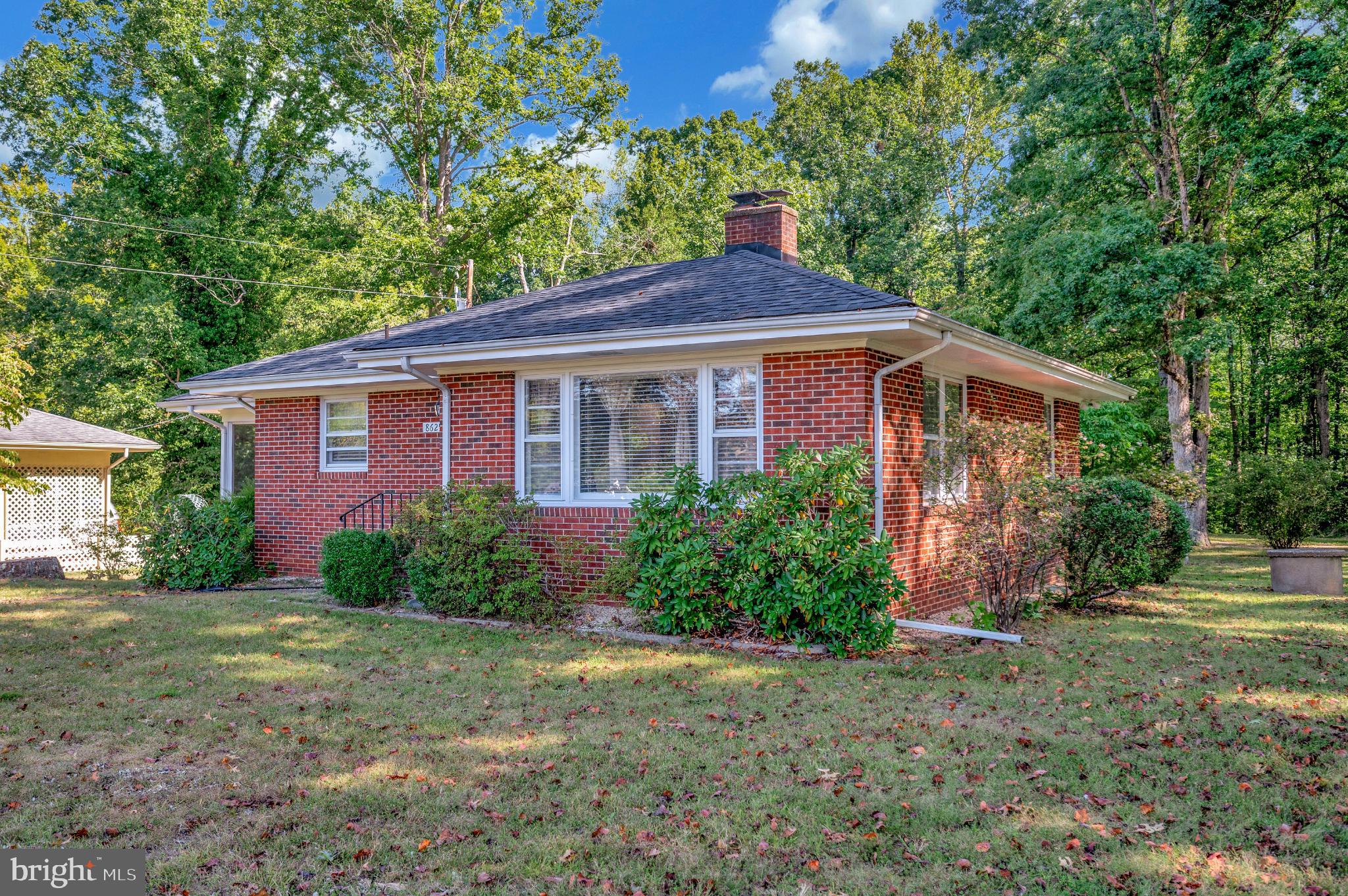 8625 Brock Road Spotsylvania, VA 22553 - Photo 44 of 47 Charming brick home nestled in lush greenery.