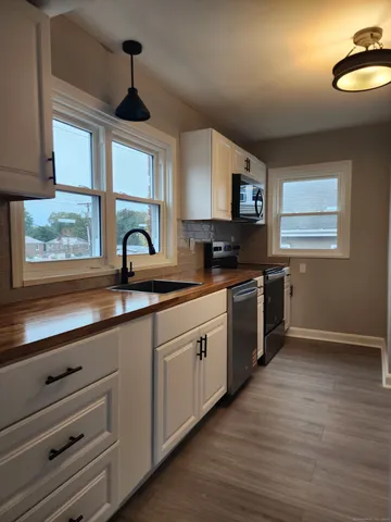 a kitchen with a sink cabinets and window