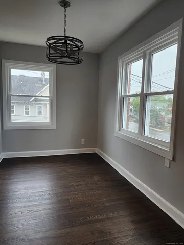 wooden floor and window in an empty room