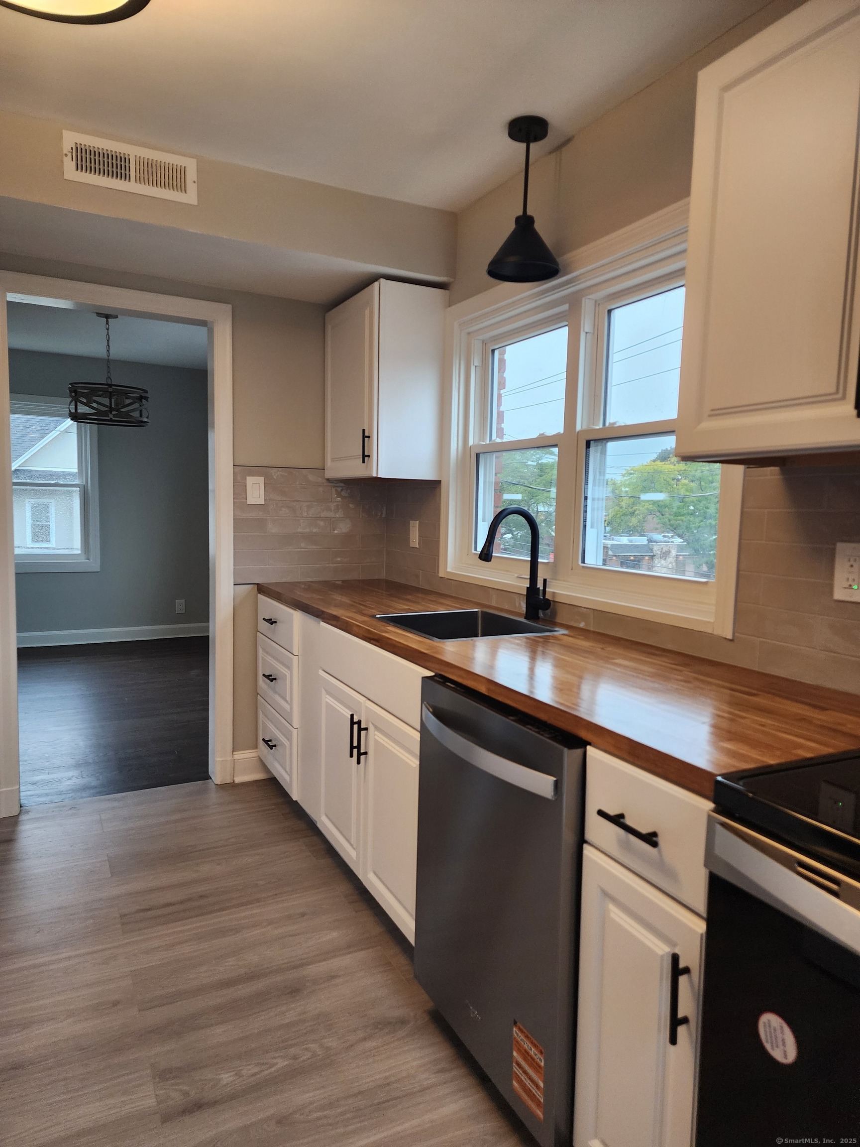 17 Shoreham Terrace Fairfield, CT 06824 - Photo 2 of 13 a kitchen with stainless steel appliances granite countertop a sink a stove cabinets and a window