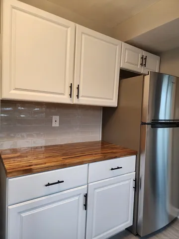 a view of a closet with wooden cabinets