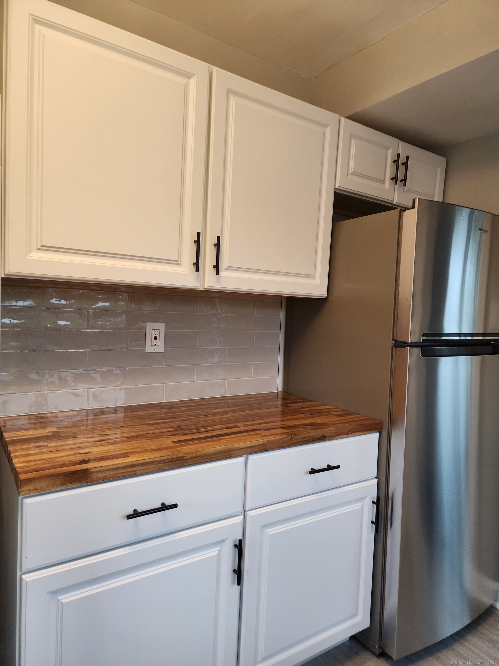 17 Shoreham Terrace Fairfield, CT 06824 - Photo 4 of 13 a view of a closet with wooden cabinets