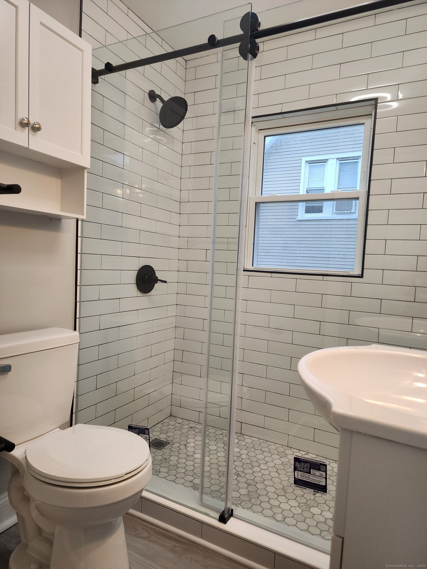 17 Shoreham Terrace Fairfield, CT 06824 - Photo 9 of 13 a bathroom with a sink a toilet and shower