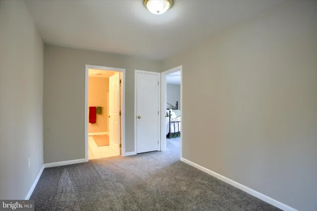 an empty room with a window and entrance