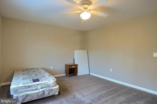 a living room with couch and a ceiling fan