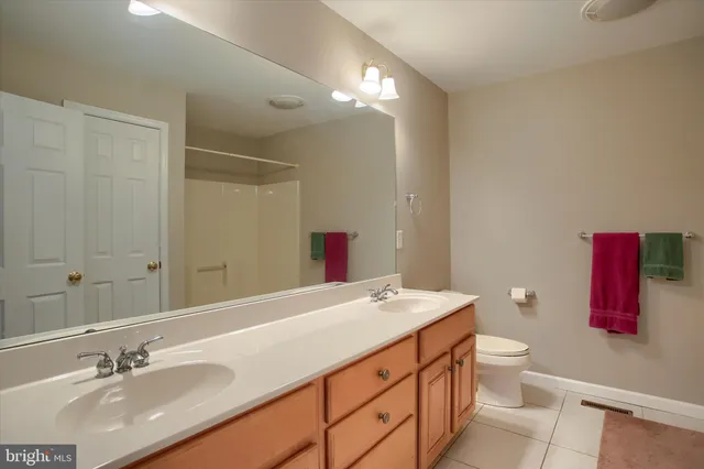 a bathroom with a sink a toilet and mirror