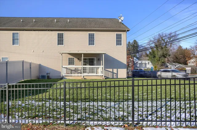 a view of a house with a yard and sitting area