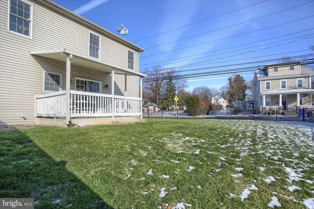 a view of a patio with table and chairs with wooden floor and fence