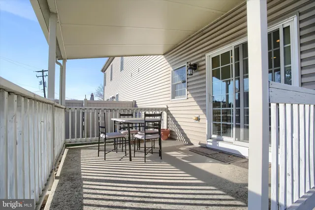 a view of a chair and tables and the floor to ceiling window