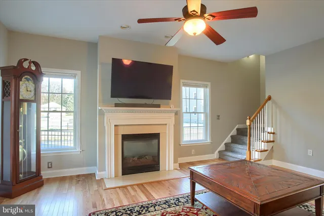 a living room with a fireplace and a flat screen tv