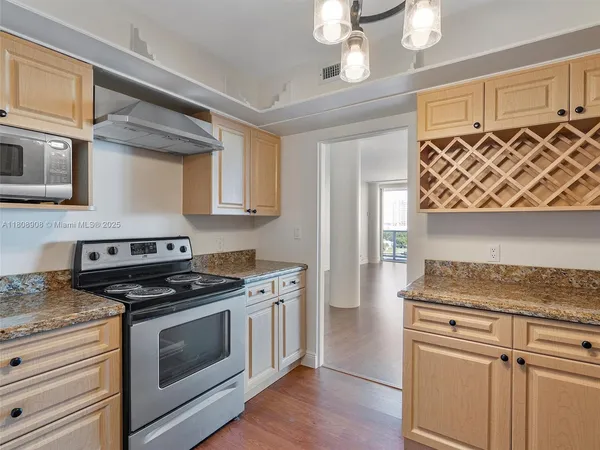 a kitchen with stainless steel appliances granite countertop a stove and a sink