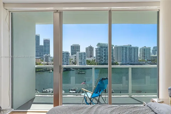 a balcony with a table and chairs