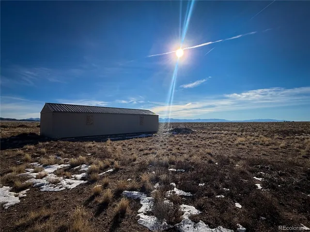 a living room with furniture a flat screen tv and floor to ceiling window